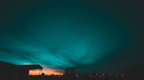 Low angle view of illuminated city against sky