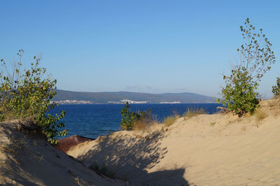 Scenic view of sea against clear blue sky