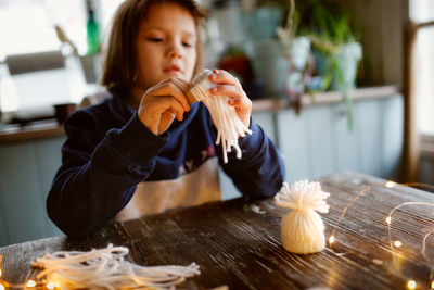 Girl sitting at table in home