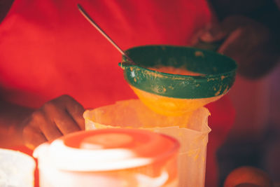 A person preparing an orange juice to sell