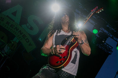 Man playing guitar at music concert