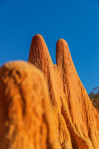 Low angle view of desert against clear blue sky