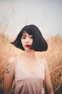 Portrait of beautiful young woman on land