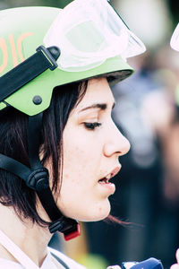 Close-up portrait of a beautiful young woman looking away