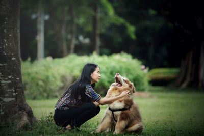 Man with dog sitting on land
