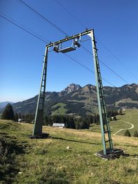 Built structure on field against clear blue sky