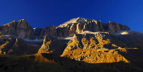 Scenic view of mountains against clear blue sky