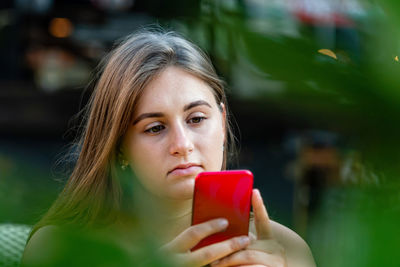 Young woman using phone outdoors