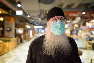 Bearded man wearing mask in store