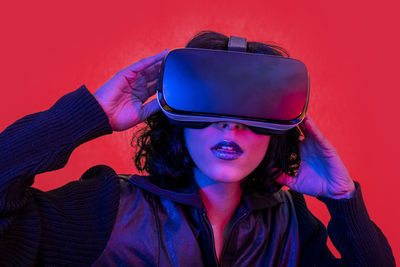 Woman is using the virtual reality headset.modern woman portrait with trendy look and bright colors.