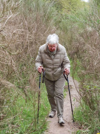 Full length of man standing in forest