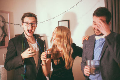 Happy friends drinking glass