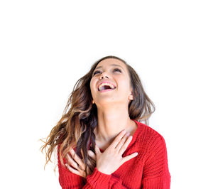 Portrait of young woman against white background