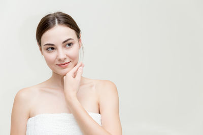 Portrait of a smiling young woman over white background