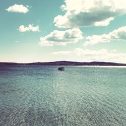 Scenic view of sea against cloudy sky