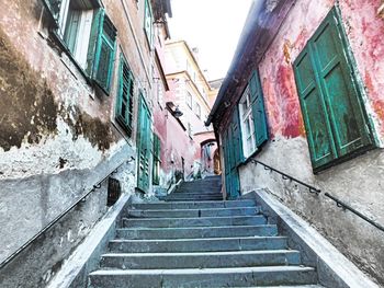 Staircase amidst residential buildings against sky