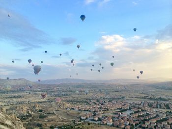 Hot air balloons flying over townscape 