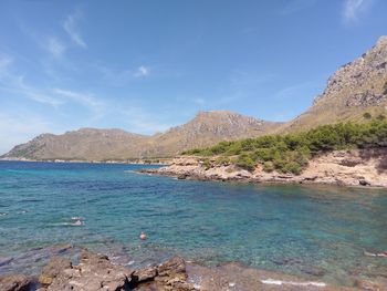 Scenic view of sea and rocks against sky