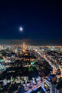 High angle view of illuminated cityscape against sky at night