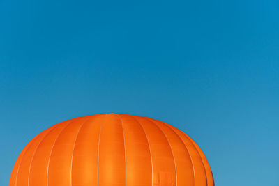 Low angle view of hot air balloon against clear blue sky