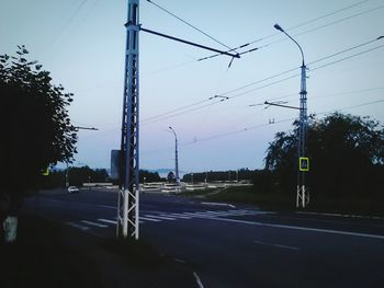 Electricity pylon against cloudy sky