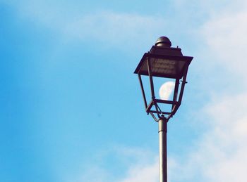 Low angle view of street light against blue sky