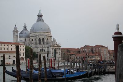 Boats moored in canal against church of san giorgio maggiore