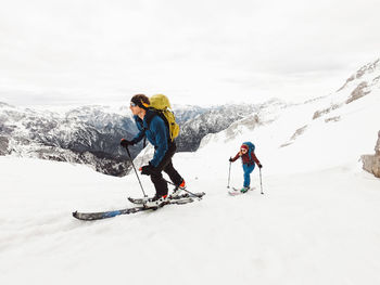 Low angle view of man skiing on snow covered landscape