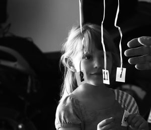 Close-up of girl looking at numbers indoors