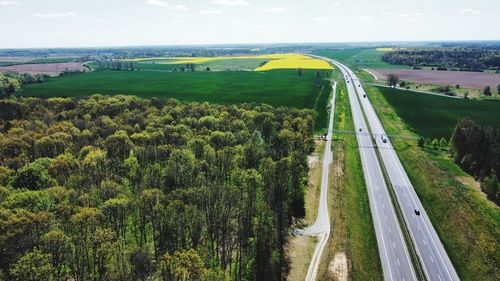 High angle view of road amidst trees against sky