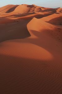 Scenic view of sand dune in desert against sky