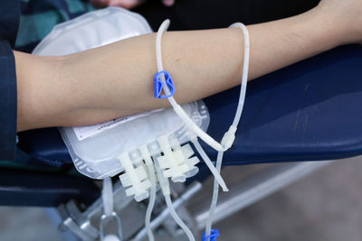 Cropped image of man donating blood in hospital