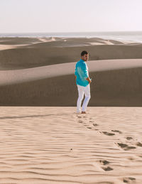 Full length of boy running on beach