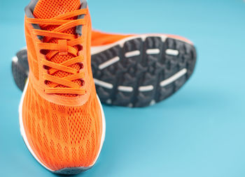 Close-up of oranges on table against blue background