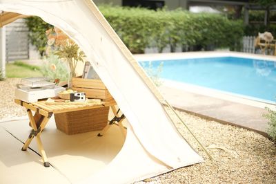 Close-up of lounge chairs by swimming pool