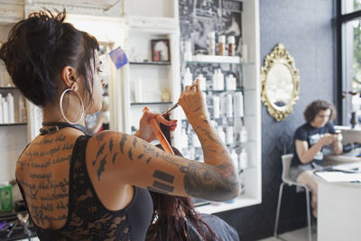 A hairdresser styling a customer's hair. 