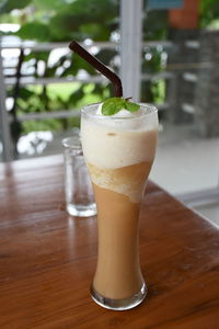 Close-up of cold coffee on wooden table