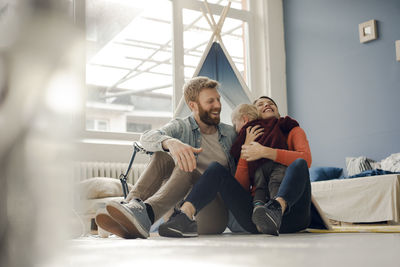 Young couple sitting on floor