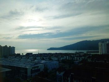 High angle view of townscape by sea against sky