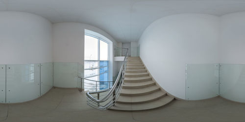  360 degree panorama in equirectangular projection of stairway with white walls with glass panels