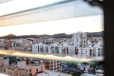 High angle view of buildings in city against sky