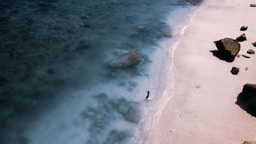 Aerial view of woman standing on beach