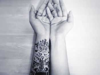 Cropped image of man and woman hands on table