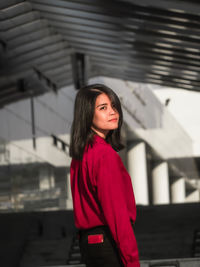 Portrait of beautiful young woman standing outdoors