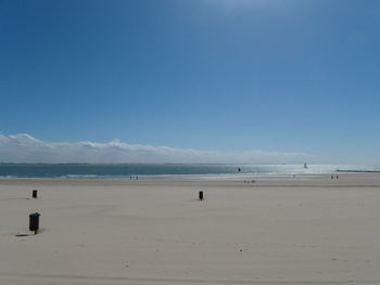 Scenic view of beach against blue sky