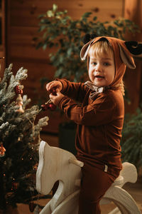 Full length of a smiling boy with christmas tree