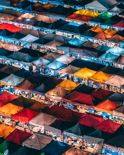 High angle view of multi colored tents at market stall in city during night