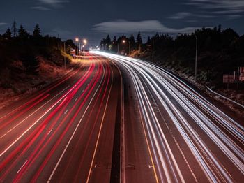 High angle view of light trails on highway at night