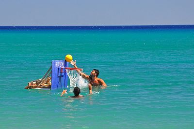 People playing basketball in water