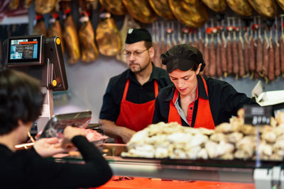 Owners selling food at butcher shop